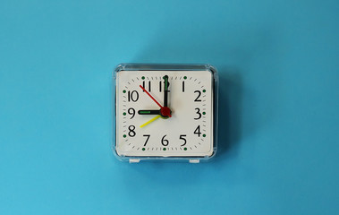 a desk clock on a tinted background.