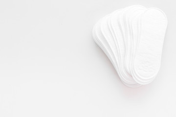 Women's hygiene products. Critical days concept. Sanitary pads on white background top view copy space