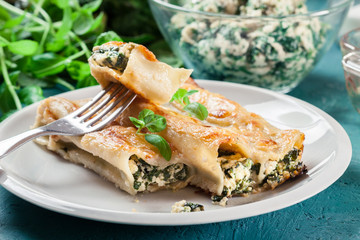 Portion of cannelloni stuffed with spinach