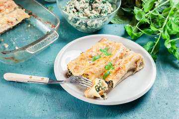 Portion of cannelloni stuffed with spinach