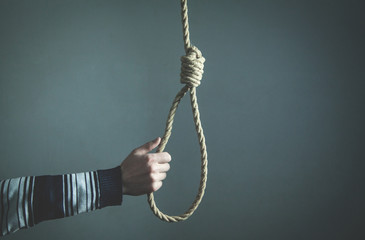 Hand holding rope loop. Suicide concept © andranik123
