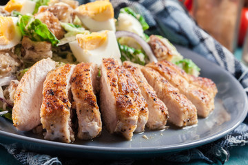 Healthy caesar salad with chicken, eggs and croutons