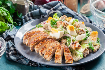 Healthy caesar salad with chicken, eggs and croutons