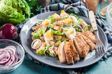 Healthy caesar salad with chicken, eggs and croutons