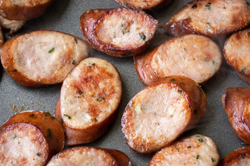 Close up on a pile of sliced sausage in a nonstick frying pan