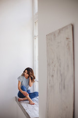 Fototapeta premium Beautiful girl by the window.