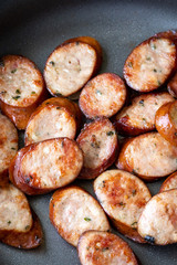 Close up on sliced sausage in a pan