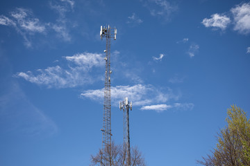 Obraz premium Telecommunication tower in European Union. Dark blue sky with white clouds in the background