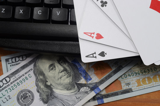 virtual casinos, real money. keyboard, dollar and playing cards