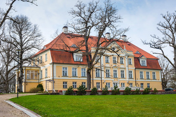 The ancient manor against the background of the blue sky.