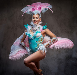 Beautiful girl in a sumptuous carnival feather suit.