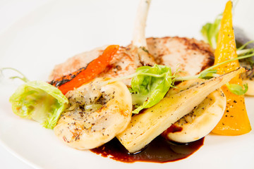 Meat dish with vegetables on a white background