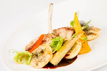 Meat dish with vegetables on a white background