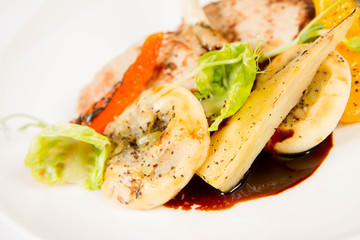 Meat dish with vegetables on a white background