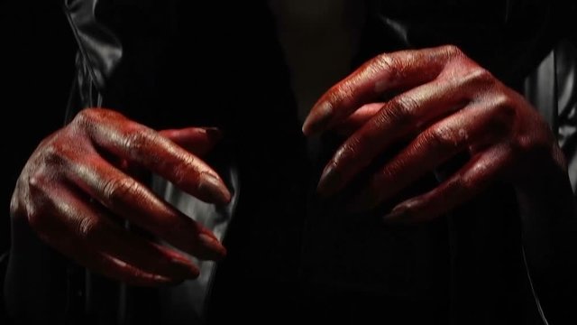 Blood hands of young woman in image