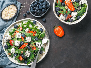 Salad with arugula, feta, strawberry, blueberry