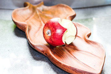 there is an Apple on a wooden piece