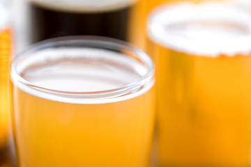 Macro close up on a pint of beer with suds on the surface