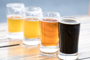 Rainbow selection of craft beers with ascending volumes