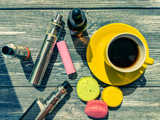 Still life with e-cig and jiuce on the wooden background