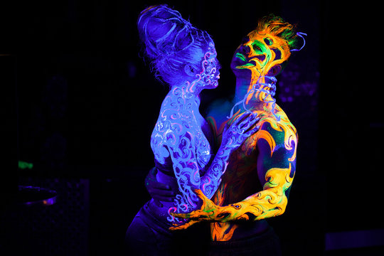 Fire and Air. Body art glowing in ultraviolet light, four elements, isolated on black background