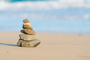 Zen stone little pile on sea beach