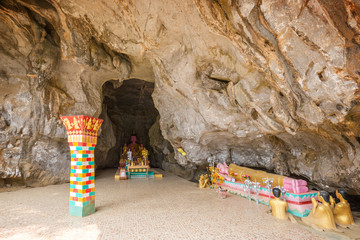 Ornate column and Reclining Buddha statue at the entrance to the Tham Sang (or Xang) Cave, also known as the Elephant Cave, near Vang Vieng, Vientiane Province, Laos.