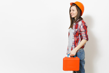 Young smiling beautiful woman in casual clothes protective hardhat holding case with instruments or toolbox isolated on white background. Instruments, tools for renovation room. Repair home concept.