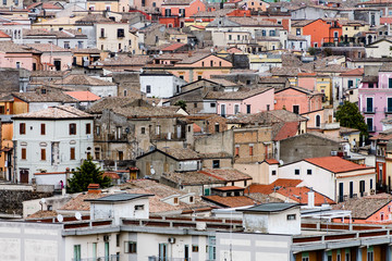 Fototapeta na wymiar roofs of houses in a densely populated area, urban slums, a densely populated city, houses from a height against the sky