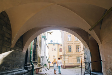 Romantic couple on a walk in France, summer honeymoon in europe with young family on a trip in old town, walking in old alley way