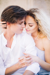 Newlywed couple portrait, hipster couple on honeymoon face closeup, beautiful blonde woman hugging handsome man in white shirt