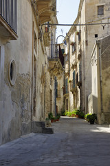 Old Italy, narrow street in old city of Modica, Sicily - Italy.