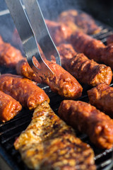 Close up pf delicious chicken breast on wooden skew with fresh vegetables, garlic, paprika fried on mangal barbeque grill