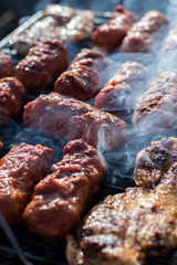 Close up pf delicious chicken breast on wooden skew with fresh vegetables, garlic, paprika fried on mangal barbeque grill