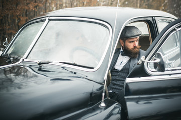 Couple in love on romantic date. Travel and business trip or hitch hiking. Escort of girl by security. Bearded man and sexy woman in car. Retro collection car and auto repair by mechanic driver.