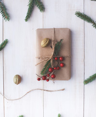 Christmas gift boxes and fir tree branch on wooden table, flat lay. Сhristmas background