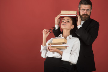 Education in knowledge day. Literature lesson and reading grammar book. Teacher man and girl hold book pile on head. Back to school and home schooling. School time of daughter and father in library.