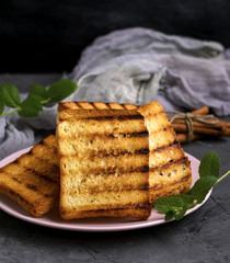 Fried square pieces of white wheat flour in a ceramic pink plate