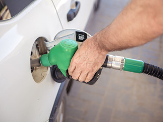 close up man hand filling the white car with fuel