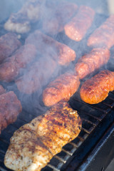 Close up pf delicious chicken breast on wooden skew with fresh vegetables, garlic, paprika fried on mangal barbeque grill