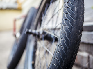 close up bmx bicycle parts outdoors on the ground tires wheels and rudder