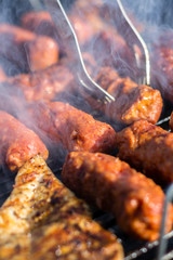 Close up pf delicious chicken breast on wooden skew with fresh vegetables, garlic, paprika fried on mangal barbeque grill