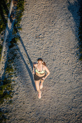 Young fit blonde woman running in the park