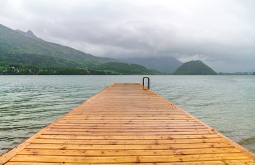 Wooden Pier with scenic view over the lake and mountains