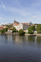 Spring green Prague Lesser Town with gothic Castle above River Vltava in the sunny Day, Czech...