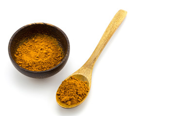 Turmeric (Curcuma) powder on wooden spoon on white background.