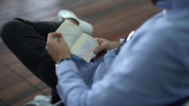 Guy checking passport on airport