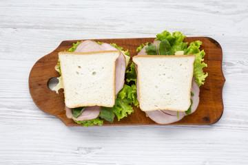Ready-made sandwiches on a wooden board, top view