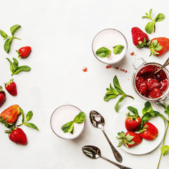 Strawberry milkshake with mint, white background, top view