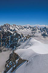 Snowy peaks in a sunny day, viewed from the Aiguille du Midi, near Chamonix. A famous ski resort located in Haute-Savoie Province, at the foot of Mont Blanc in the French Alps. Retouched photo